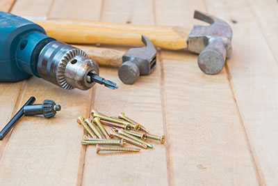Screw driver and hammers with pile of screws